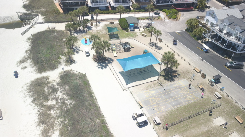 Playground and shaded shuffleboard area at Ocean Lakes