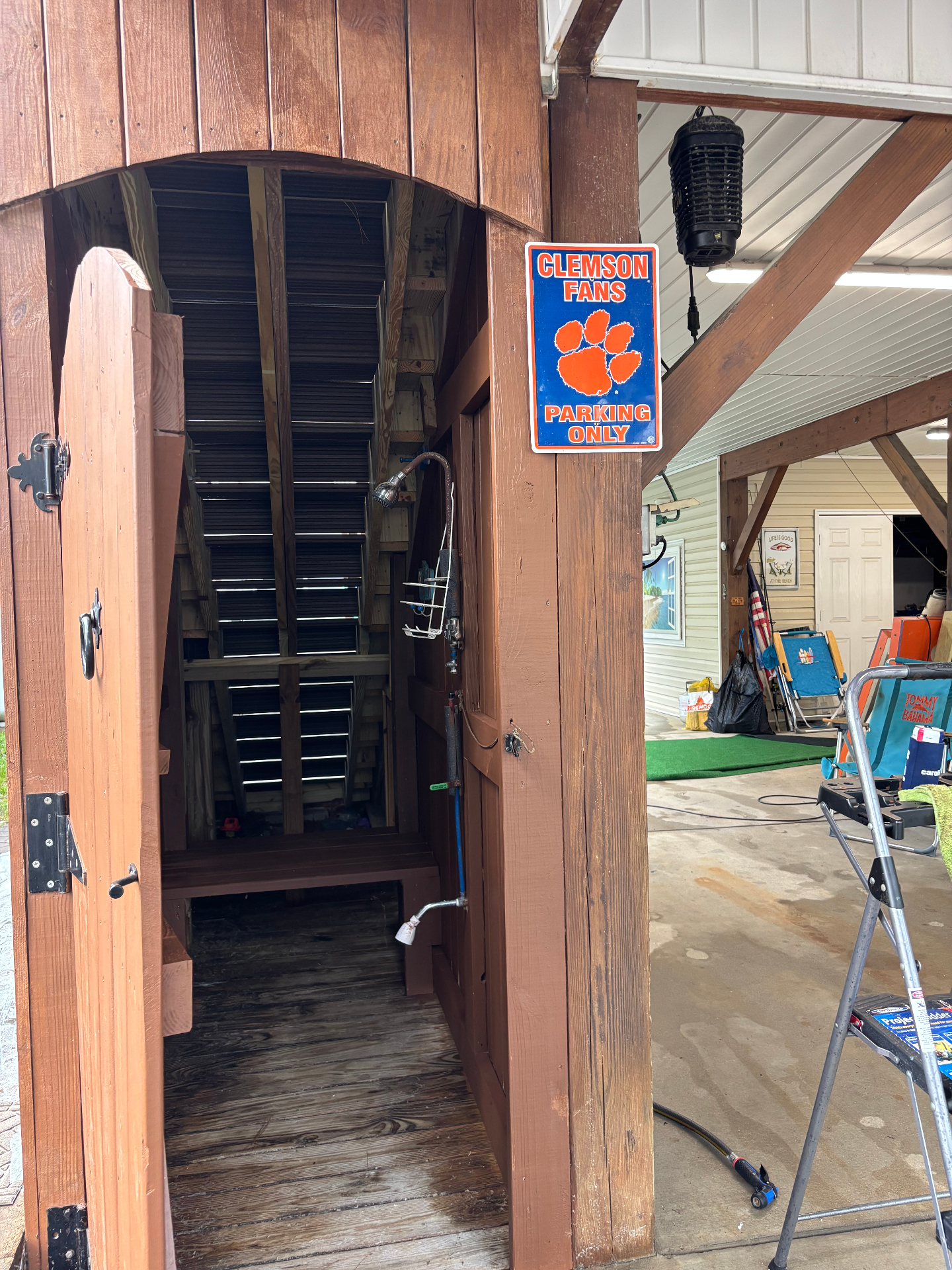 Outdoor shower enclosure under the house